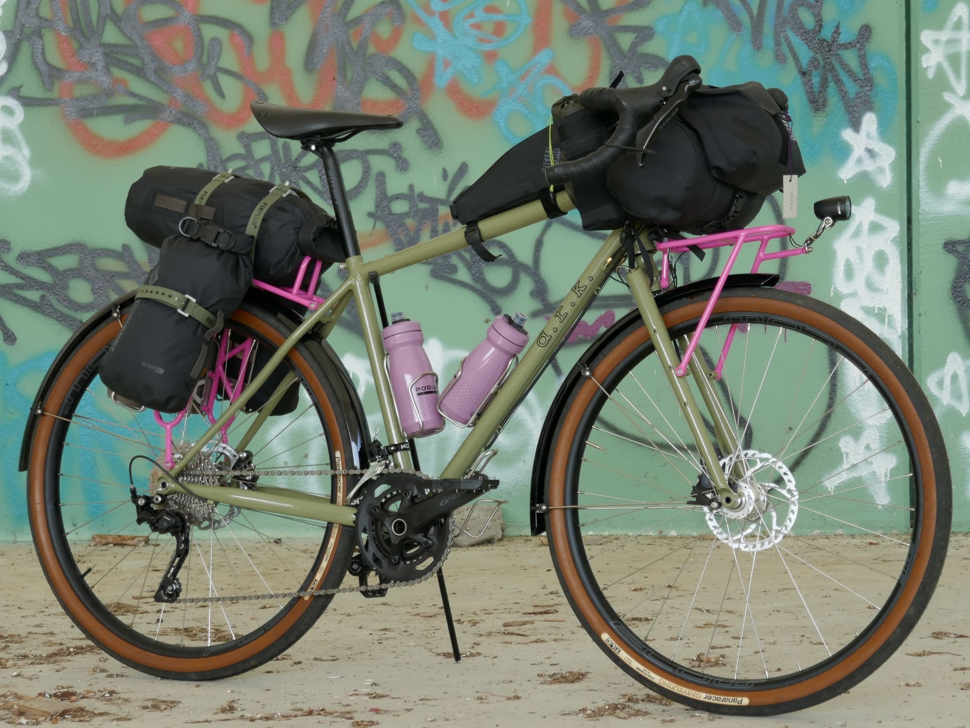 custom hand-made green bicycle with several mounting points for racks and bottles