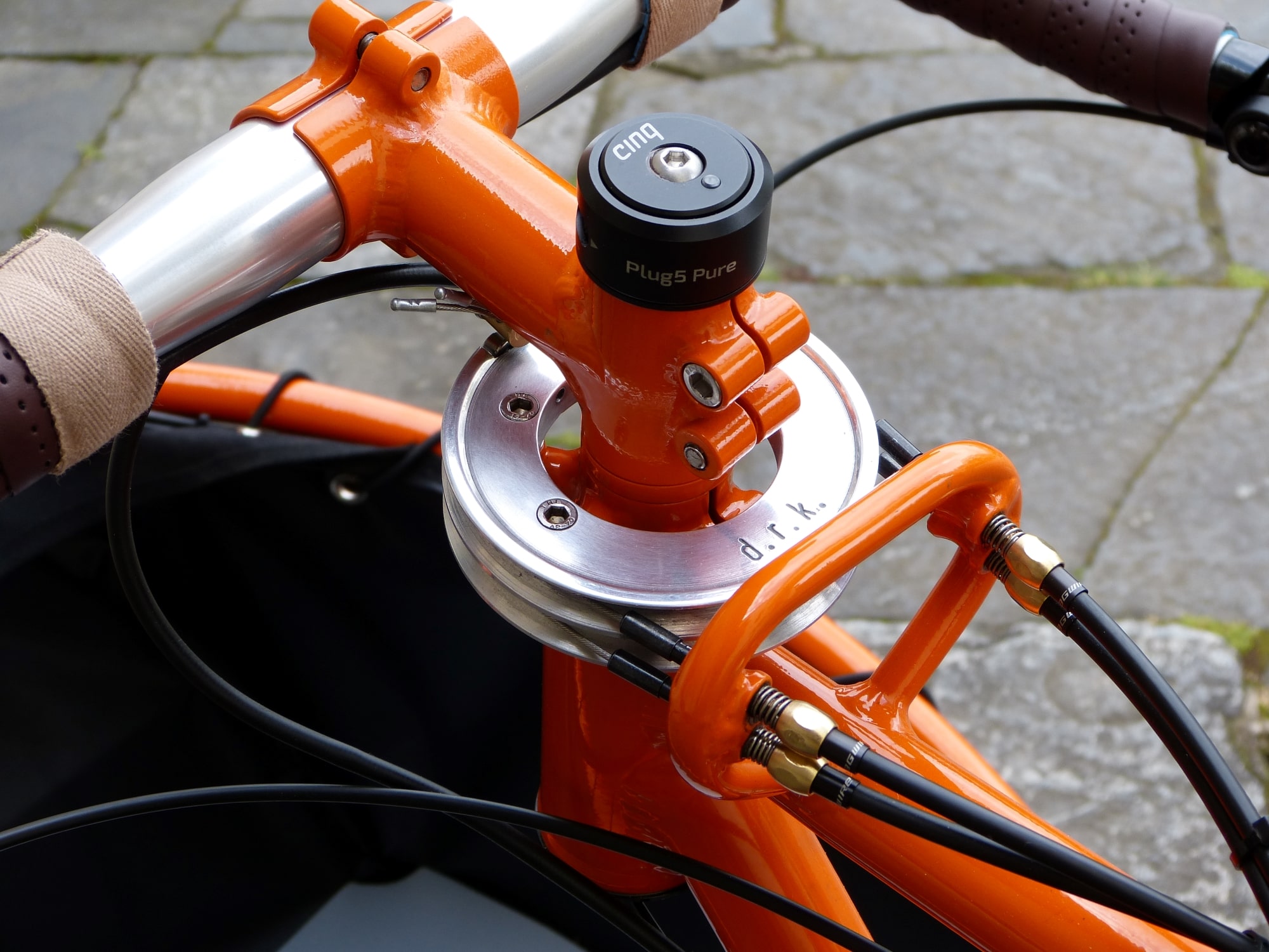 detail of an orange cargo bike with a steel pulley