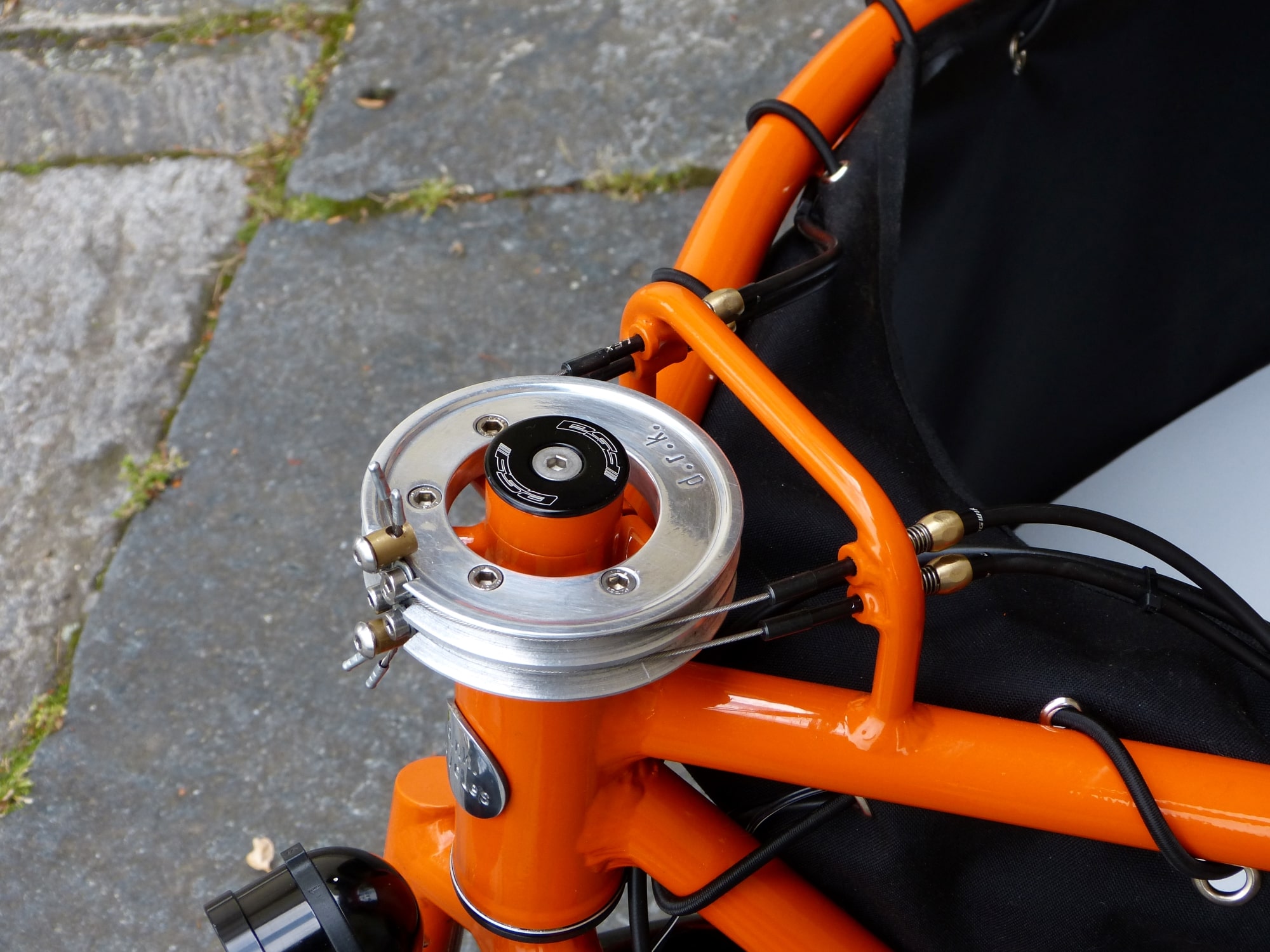 detail of an orange cargo bike with a steel pulley