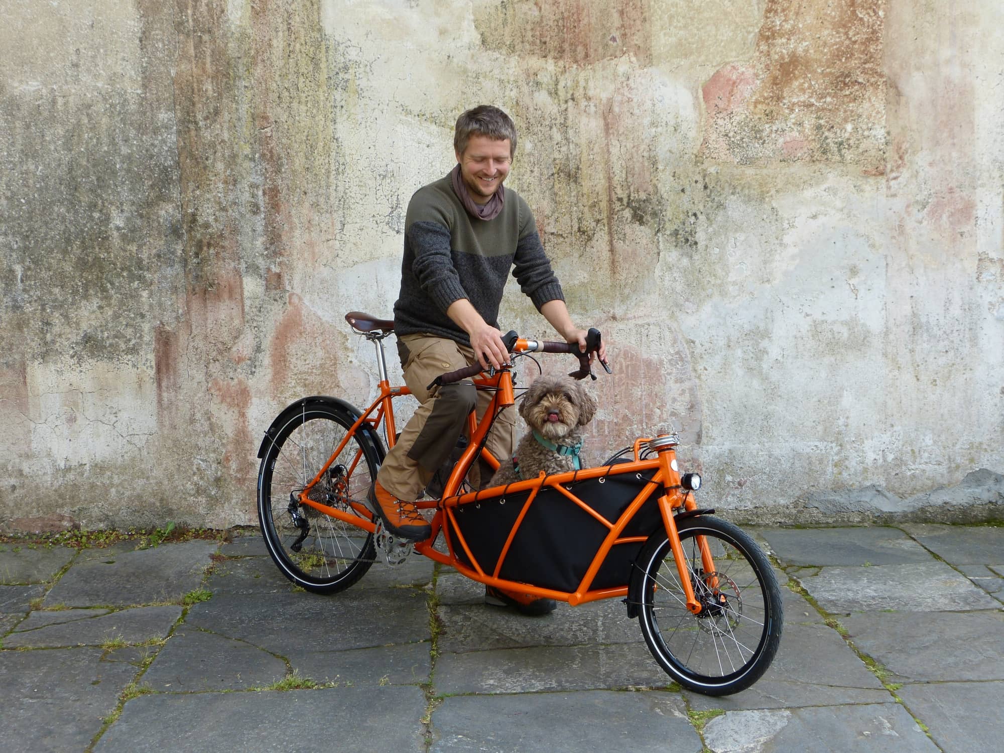 custom hand-made orange cargo bike with Daniel and Zola