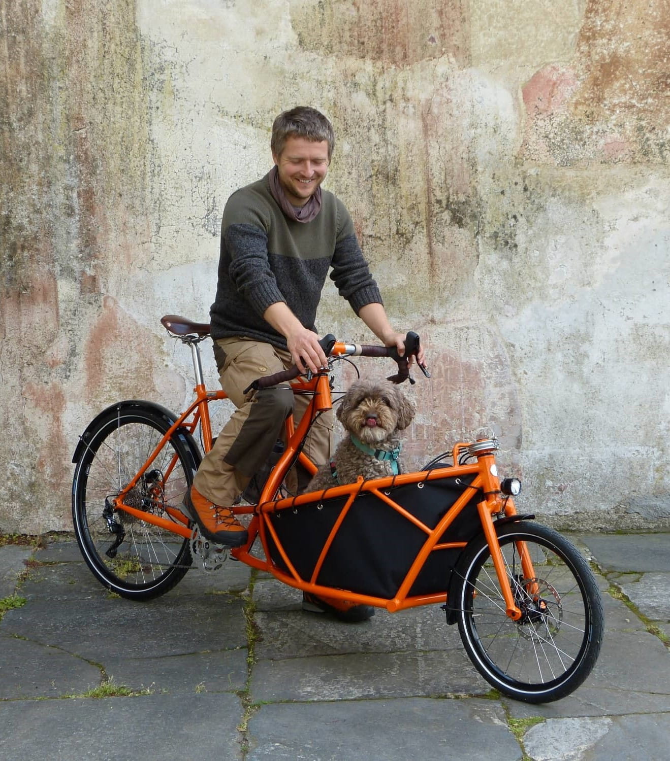 custom hand-made orange cargo bike with Daniel and Zola