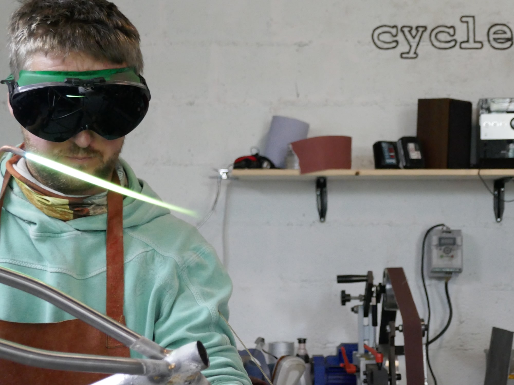 Daniel brazing a bicycle frame in a workshop