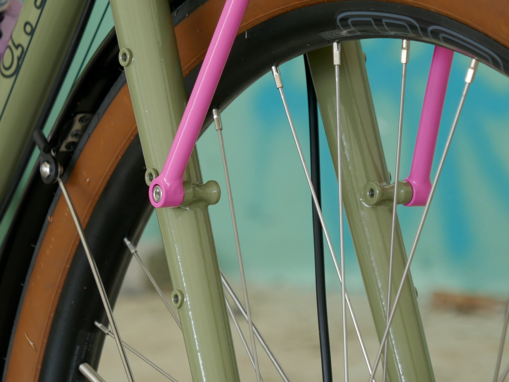 detail of green gravel bike with pink rack